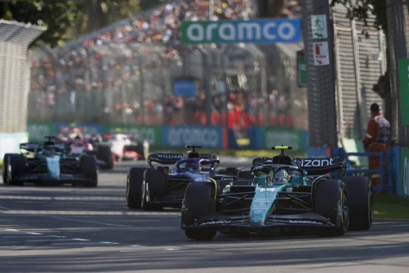 Fernando Alonso, Aston Martin AMR23, leads Alex Albon, Williams FW45, and Lance Stroll, Aston Martin AMR23