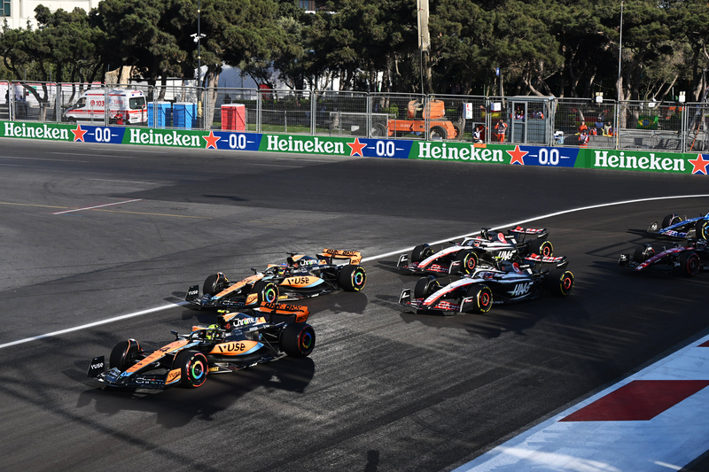 Lando Norris, McLaren MCL60, leads Oscar Piastri, McLaren MCL60, Nico Hulkenberg, Haas VF-23, and Kevin Magnussen, Haas VF-23
